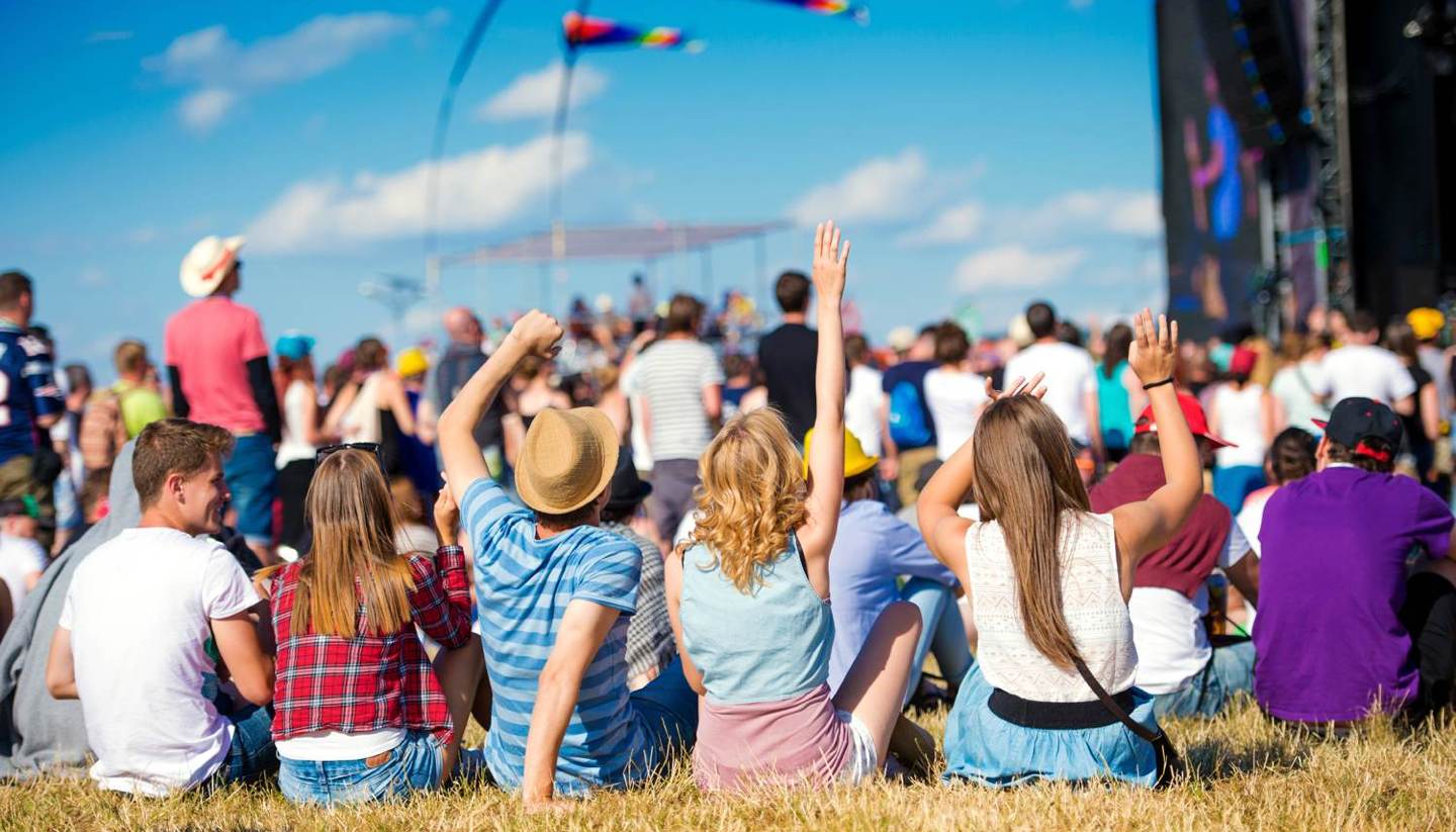 Top 10 music festivals around the world - Young people enjnoying themselves at a music festival