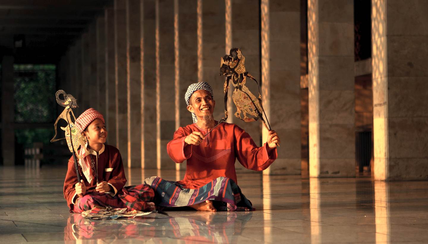 City Highlight: Jakarta - Father and son playing traditional puppet in Istiqlal Mosque Jakarta, Indonesia