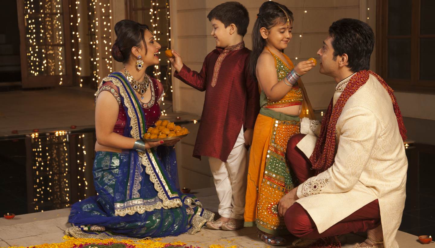 Celebrating the Festival of Lights - Children feeding parents on Diwali