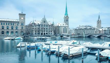 Zurich in winter - boats and roofs covered with a layer of snow