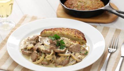 sliced veal in a creamy mushroom sauce, served with rosti, a speciality made of grated potatoes