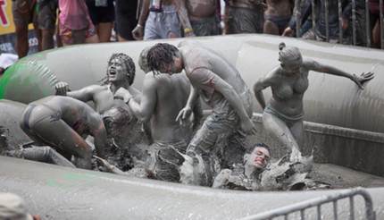 People playing in mud at the Boryeong Mud Festival
