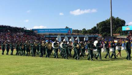 One of the marching bands - group of men in green uniforms playing band instruments