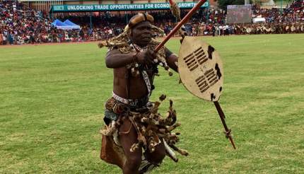 Warrior clad in traditional leopard skin loincloth, carrying a sharp spear and cowhide shield