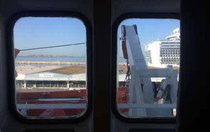 Views from the suite cabin: you see lifeboats outside the windows and a larger (nicer) cruise ship nearby