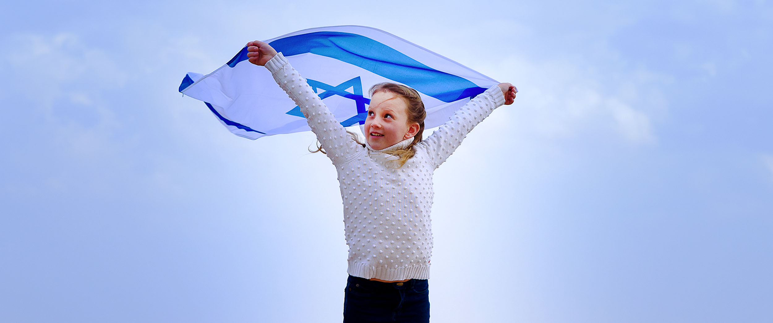 48 hours in Israel – an itinerary fit for a Prince - Girl holding Israel flag