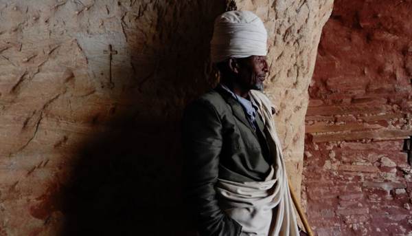 The kind priest of Abuna Yemata Guh standing by the door.