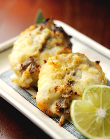 Two fried blowfish on rectangular plate with a slice of lime. Can be eaten in Takahama