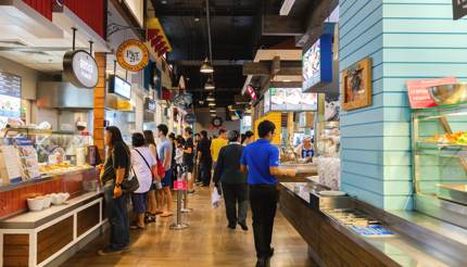 People buying street food at the food court in Terminal 21, Bangkok, Thailand