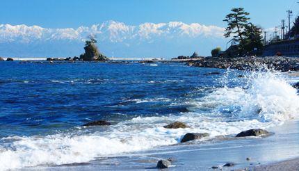 Amaharashi beach with snow-capped mountains in the background, Toyama Prefecture, Japan