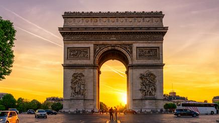 Paris Arc de Triomphe on Champs-Élysées at sunset