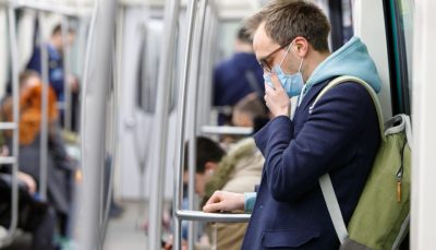 Mask-wearing passengers on a train