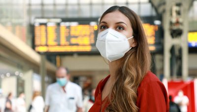 A mask-wearing passenger at the departure lounge