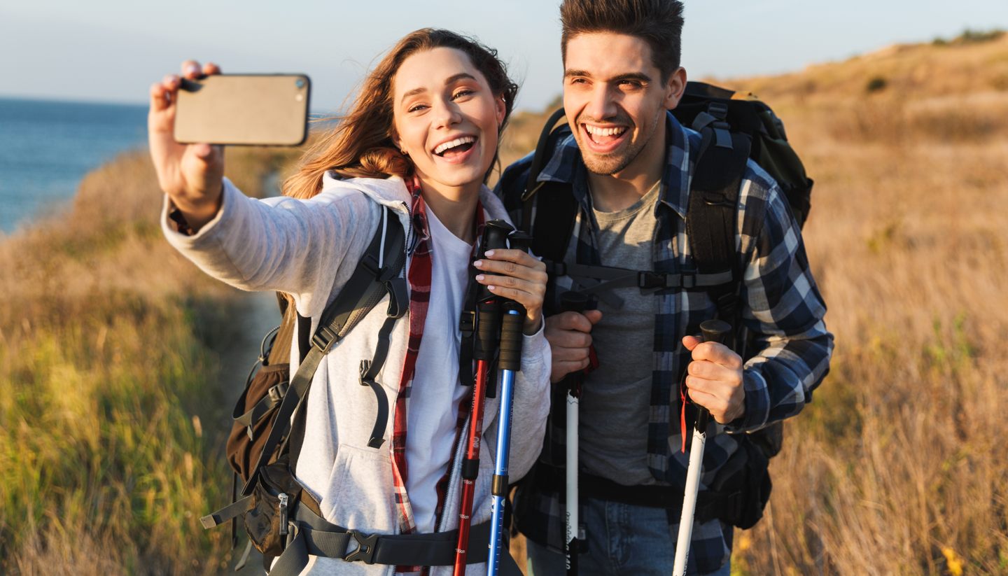 The 7 best cliché-free Valentine’s Day breaks - A couple hiking and taking selfie