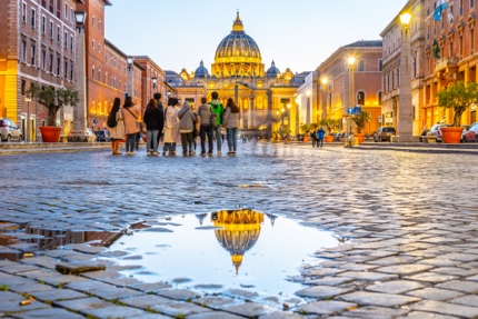 Tourists looking at St Peter's Basilica in Vatican City